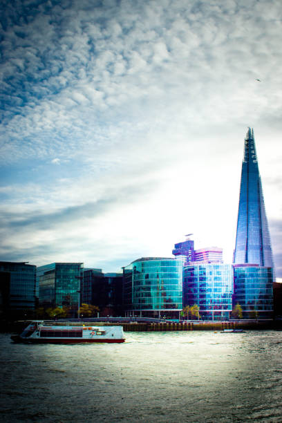 Toned Shard The Shard with a toned sunset sky behind and the Thames in the foreground. the shard close up stock pictures, royalty-free photos & images