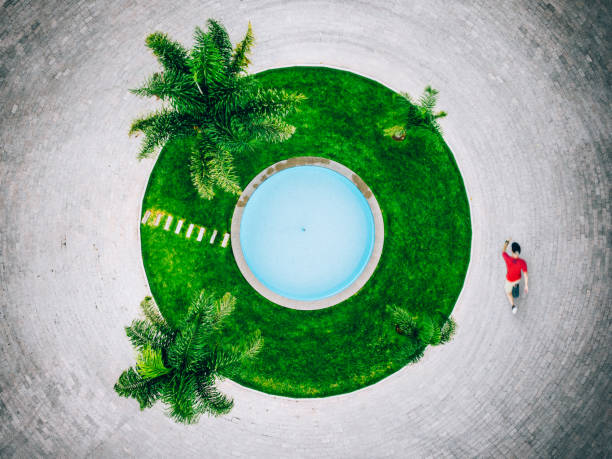 Skateboarding in Mexico Overhead view of a skateboarder passing by a roundabout in Mexico. desert oasis photos stock pictures, royalty-free photos & images