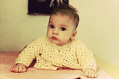 Vintage baby portrait looking at camera