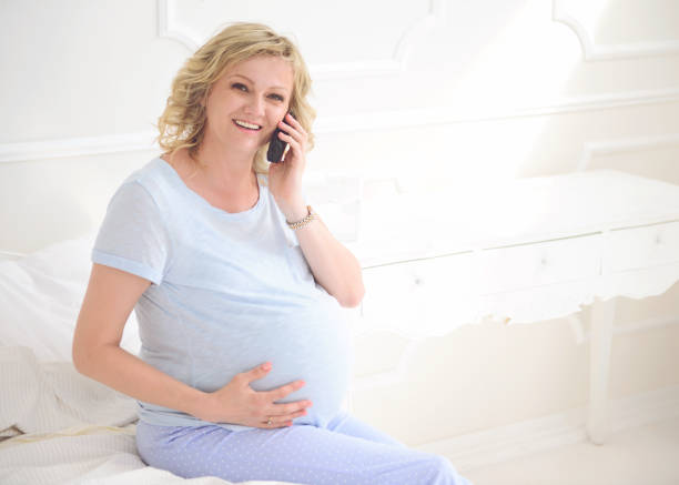 istock Middle-aged pregnant woman using phone 655903744