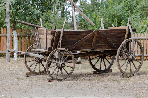 Vintage rustic wooden horse-drawn carriage on Polish farm