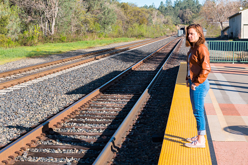 Cute Young Girl Standing Near Train Rails