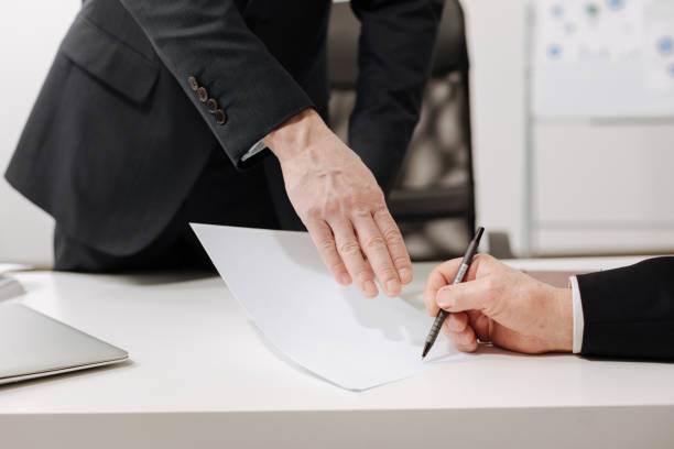 istock Confident businessman signing the important document in the office 655910042
