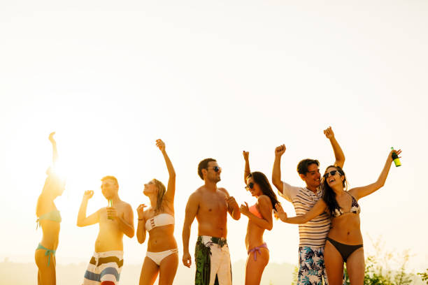 istock Group of people dancing at summer beach party 655916248