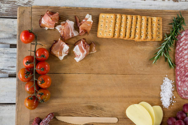 istock Roquefort cheese, biscuits and ham with various ingredients on chopping board 655916844