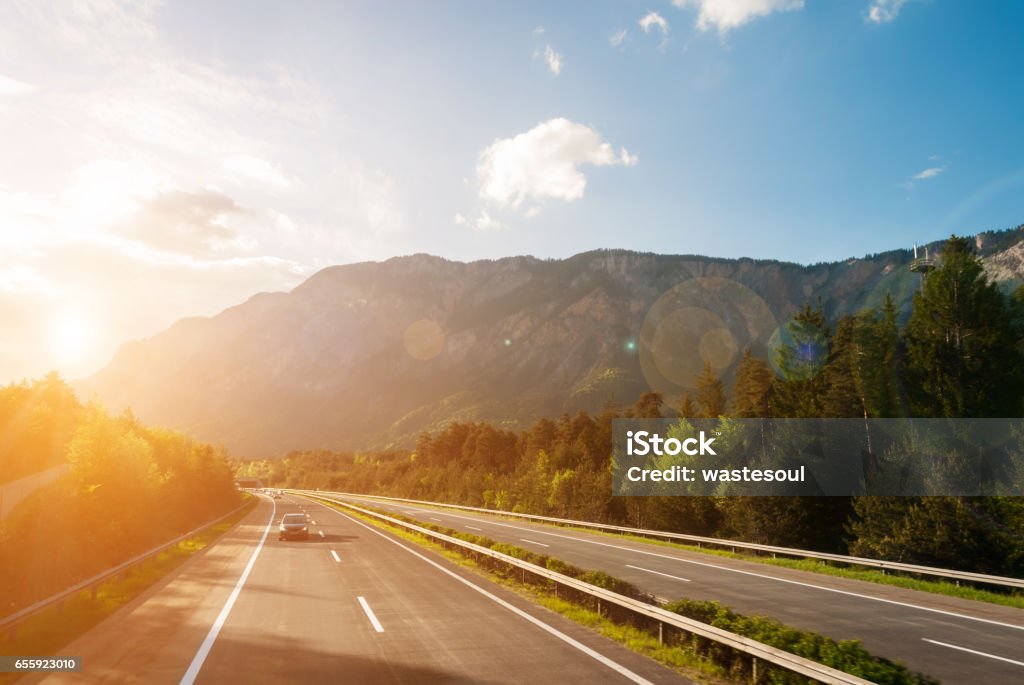 motorway Autobahn in austrian mountains at sunset Highway Stock Photo