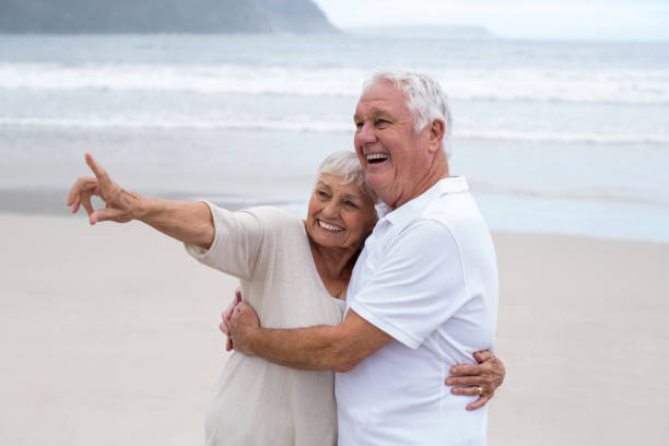 istock Senior couple embracing each other on the beach 655923692
