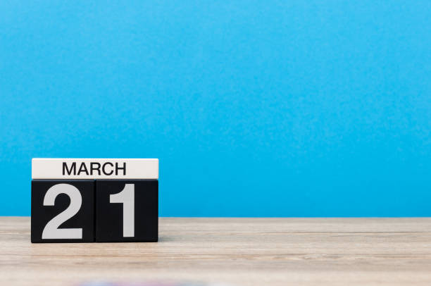 istock March 21st. Day 21 of month, calendar on table with blue background. Spring time, empty space for text 655923798