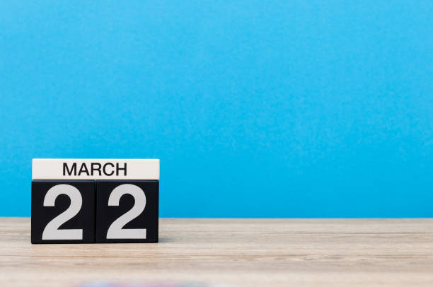 istock March 22nd. Day 22 of month, calendar on table with blue background. Spring time, empty space for text 655923938