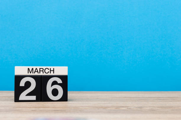 istock March 26th. Day 26 of month, calendar on table with blue background. Spring time, empty space for text 655926570