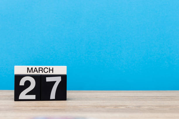 istock March 27th. Day 27 of month, calendar on table with blue background. Spring time, empty space for text. World Theatre Days 655926644