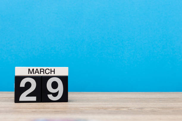 istock March 29th. Day 29 of month, calendar on table with blue background. Spring time, empty space for text 655926744