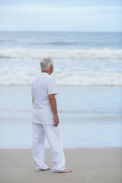 istock Senior man standing on the beach 655926800