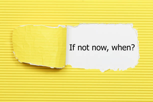 istock If Not Now When, appearing behind torn paper. 655927516