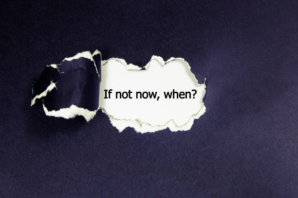 istock If Not Now When, appearing behind torn paper. 655927518