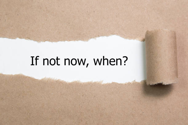 istock If Not Now When, appearing behind torn paper. 655927530
