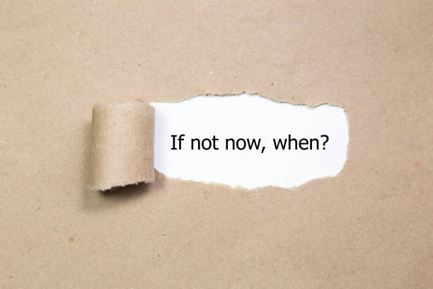 istock If Not Now When, appearing behind torn paper. 655927532