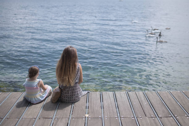 istock Mother and daughter on the sea 655931108