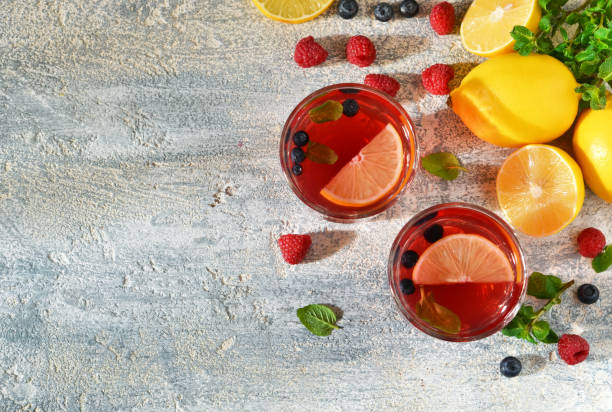 istock Cold berry drink with lemon and mint on a concrete background 655931310