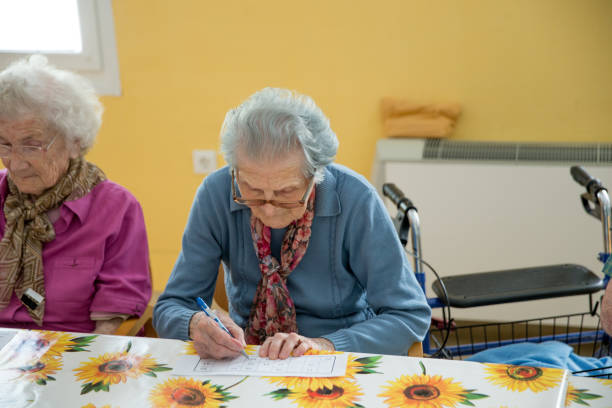 istock Seniors In The Retirement Community Enjoy Playing Bingo 655933948