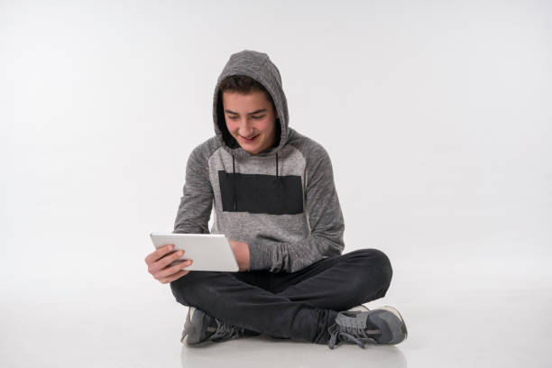 Male Handsome Teenager wit digital tablet Smiling and Posing on White Background