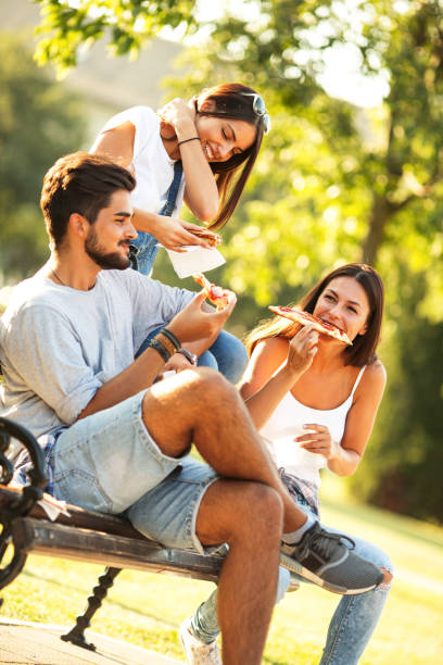 istock Group of young friends eating pizza. 655937298