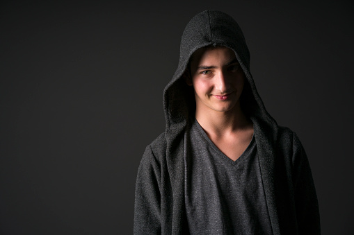 Male Handsome Teenager Smiling and Posing on black Background