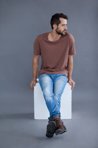 istock Man in brown t-shirt sitting on a block 655940352