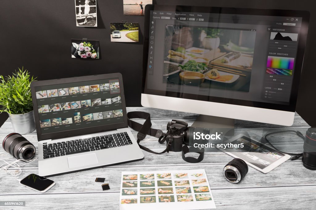 Photographers computer with photo edit programs. photographer photographic photograph journalist camera traveling photo dslr editing edit hobbies lighting concept NOTE TO INSPECTOR: All visible photos were produced for this particular shoot. I am the author of everything that you see in the image (interface program on the screen - property release added). Photography Stock Photo