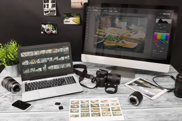 Photo of Photographers computer with photo edit programs.