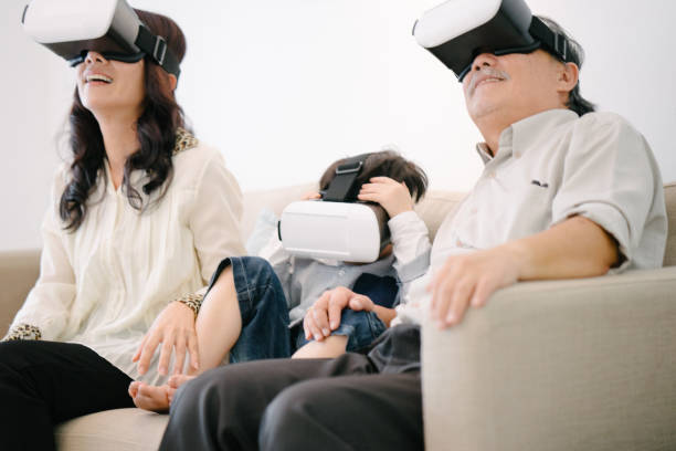 istock Grandparents and grandson wearing virtual reality headset 655944584