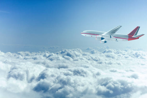 istock commercial airplane flying over the clouds 655947902
