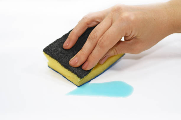 istock Woman hand with cleaning sponge and blue liquid. 655950236