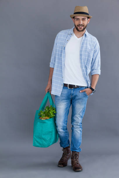 istock Man in fedora hat holding grocery bag 655950752