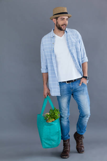 istock Man in fedora hat holding grocery bag 655950862