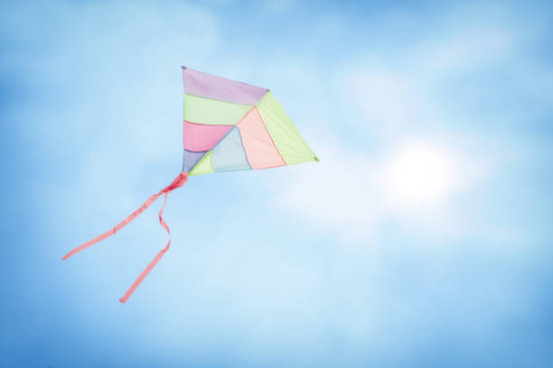 istock colorful kite flying with waving red bow 655950942