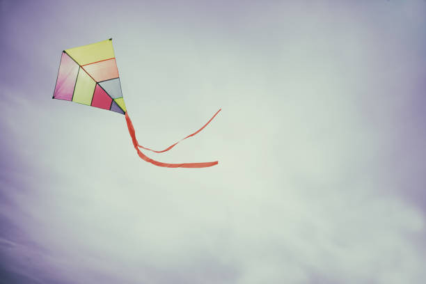 istock colorful kite flying with waving red bow 655953702