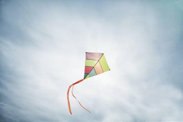 istock colorful kite flying with waving red bow 655953710