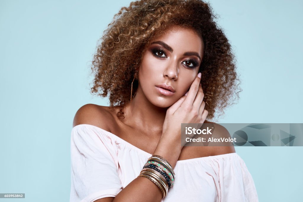 Glamour elegant black hippy woman model with curly hair Sensual portrait of glamor elegant black hippy woman model with curly hair posing on colorful background in studio One Woman Only Stock Photo