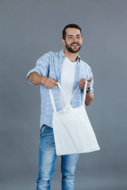 istock Happy man holding an empty shopping bag 655953918