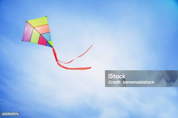 Colorful Kite Flying With Waving Red Bow Stock Photo - Download Image Now - Kite - Toy, Flying, Sky