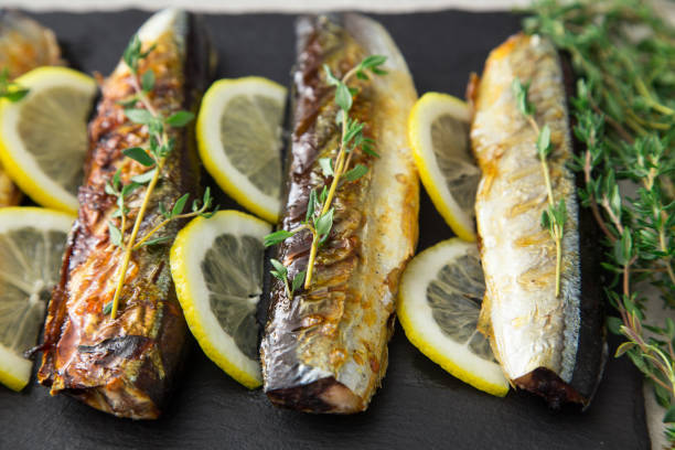 istock grilled fish saury with lemon on a slate Board 655954530