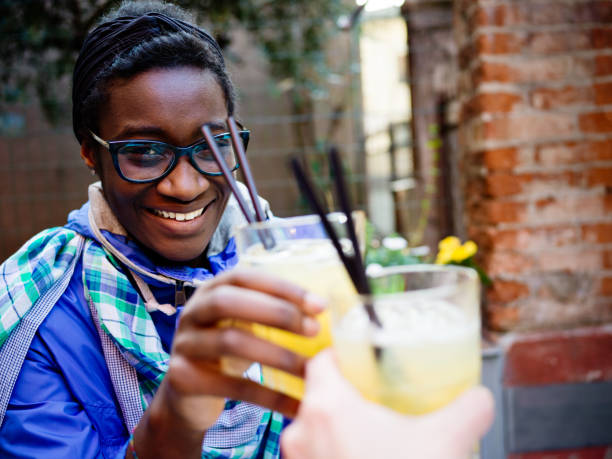 istock African young woman with cocktail in sidewalk cafe 655966652