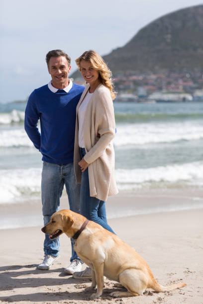 istock Mature couple on the beach with their dog 655975988