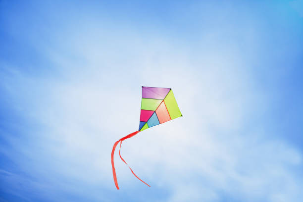 istock colorful kite flying with waving red bow 655976068
