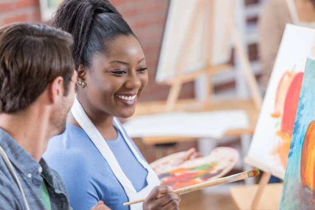 istock Beautiful African American art instructor works with a student 655976174