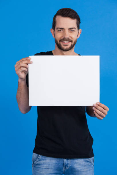istock Handsome man holding a blank placard 655976386