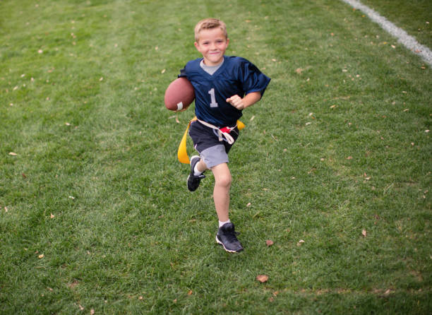 Young Boy Flag Football Player Scores Touchdown