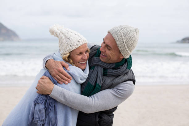 istock Mature couple embracing each other on the beach 655986640