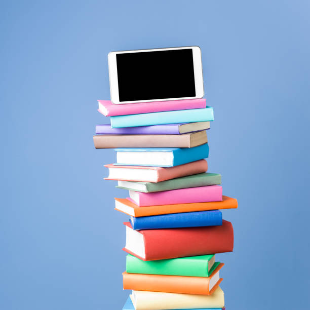 istock Tablet PC On Top Of Multicolored Hardcover Books 655998310